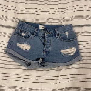 Ripped denim shorts with cuffed hem